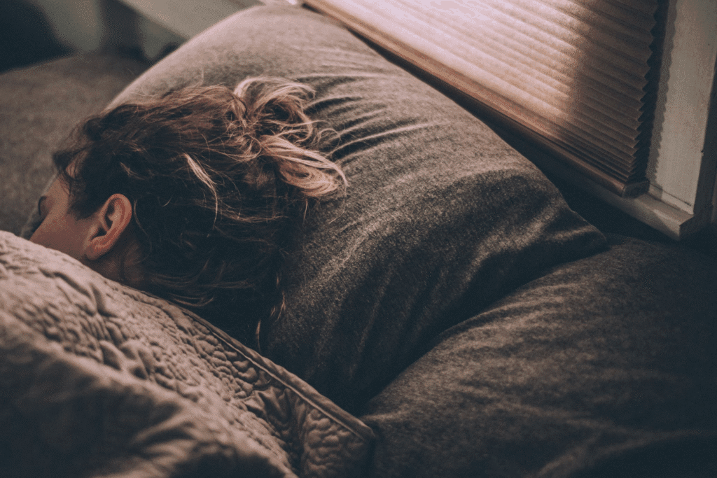Photo by <a href="https://unsplash.com/@vagabondage?utm_content=creditCopyText&utm_medium=referral&utm_source=unsplash">Greg Pappas</a> on <a href="https://unsplash.com/photos/woman-sleeping-on-bed-under-blankets-rUc9hVE-L-E?utm_content=creditCopyText&utm_medium=referral&utm_source=unsplash">Unsplash</a>
