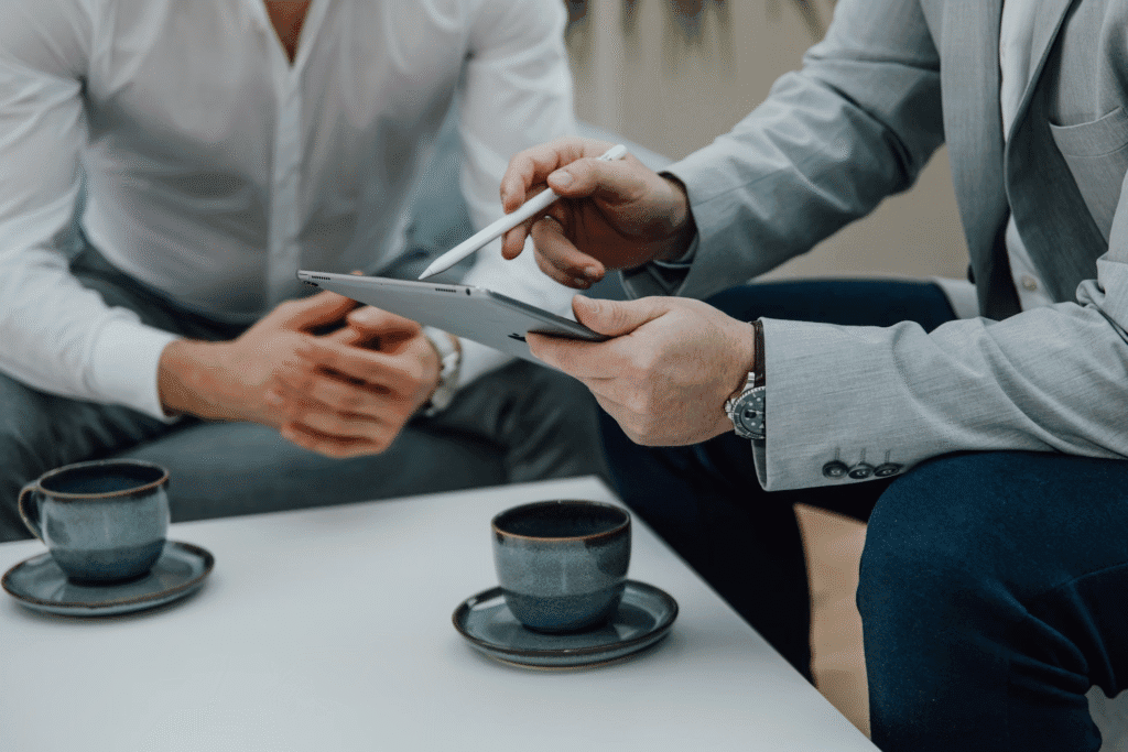 Photo by <a href="https://unsplash.com/@seogalaxy?utm_content=creditCopyText&utm_medium=referral&utm_source=unsplash">SEO Galaxy</a> on <a href="https://unsplash.com/photos/a-couple-of-people-sitting-at-a-table-with-a-tablet-Em13Jdo4u8s?utm_content=creditCopyText&utm_medium=referral&utm_source=unsplash">Unsplash</a>